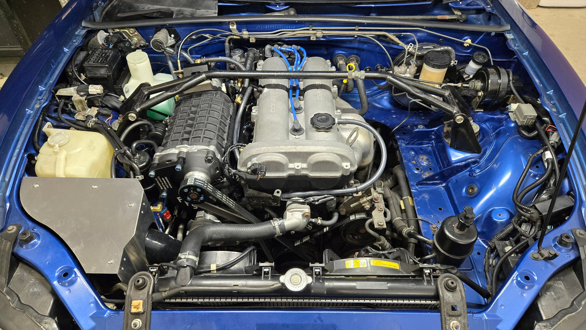Full 1999–2005 Miata engine bay with the FFS supercharger and covered coldside cold-air intake installed