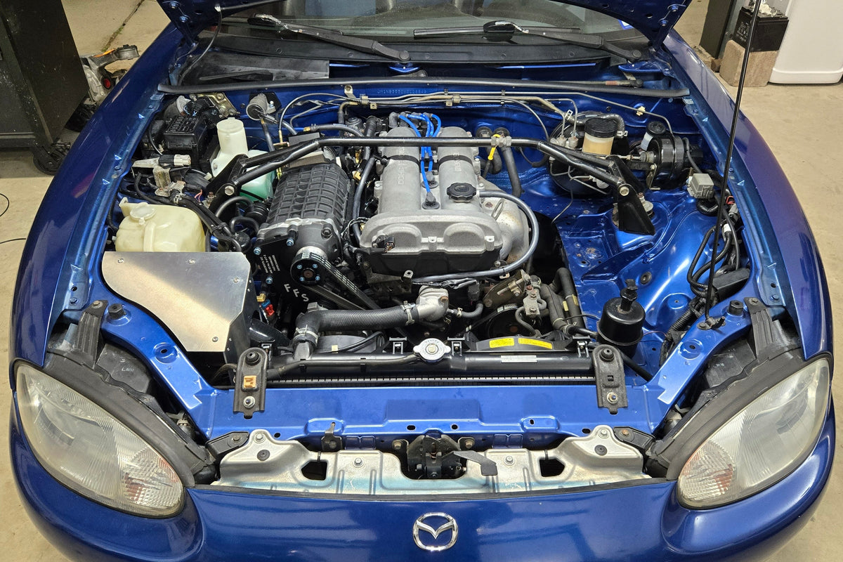 Front view of a 1999–2005 Miata engine bay with the FFS supercharger and covered coldside intake installed