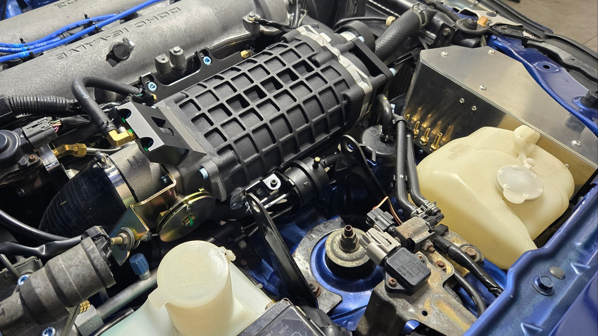 Rear view of the FFS supercharger and cold-air intake installed in a 1999–2005 Miata engine bay