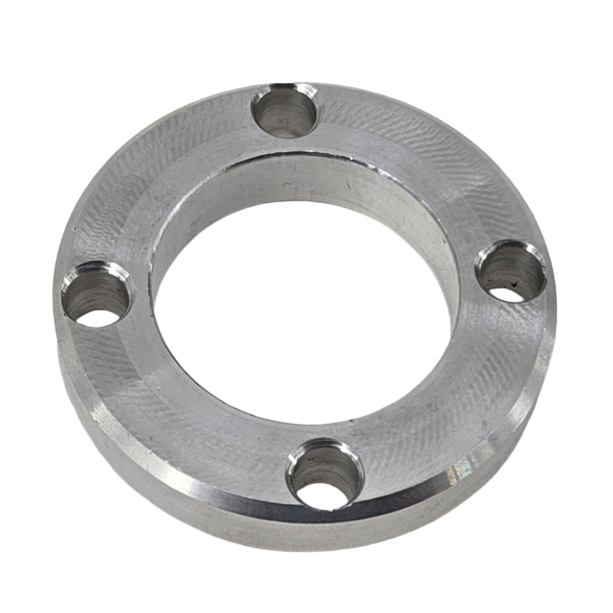 TVS900 1.6-liter Miata pulley spacer in an angled front view showing the center bore and mounting holes