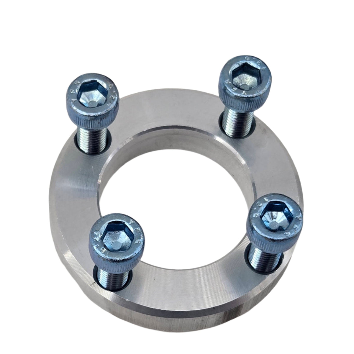 TVS900 1.6-liter Miata pulley spacer with all four socket-head bolts inserted for fitment illustration