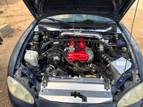 Front view of Nathaniel's blue 2001 Miata engine bay with an FFS MP62 supercharger kit