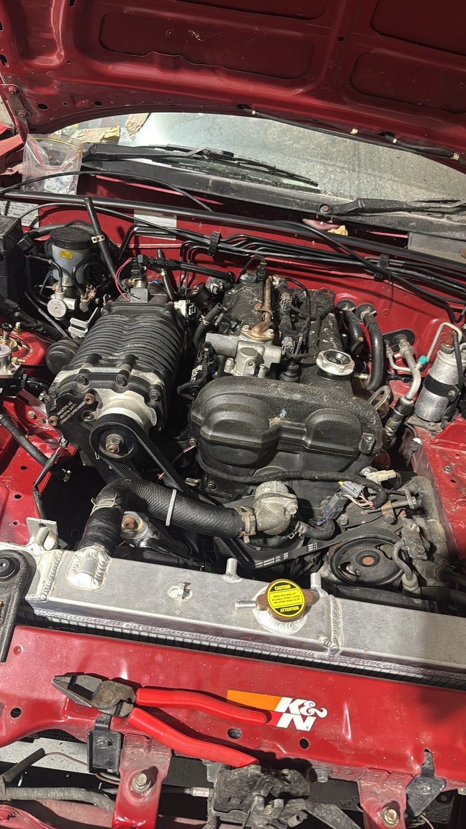 Taj's red Miata engine bay with an earlier FFS Standard Kit