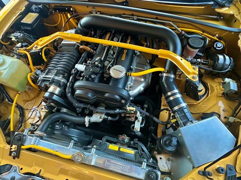Taylor's yellow 2002 Miata engine bay with an FFS Standard Supercharger Kit