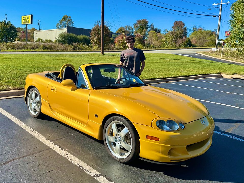 Taylor with the yellow 2002 Miata